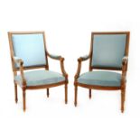 A pair of French walnut fauteuils,