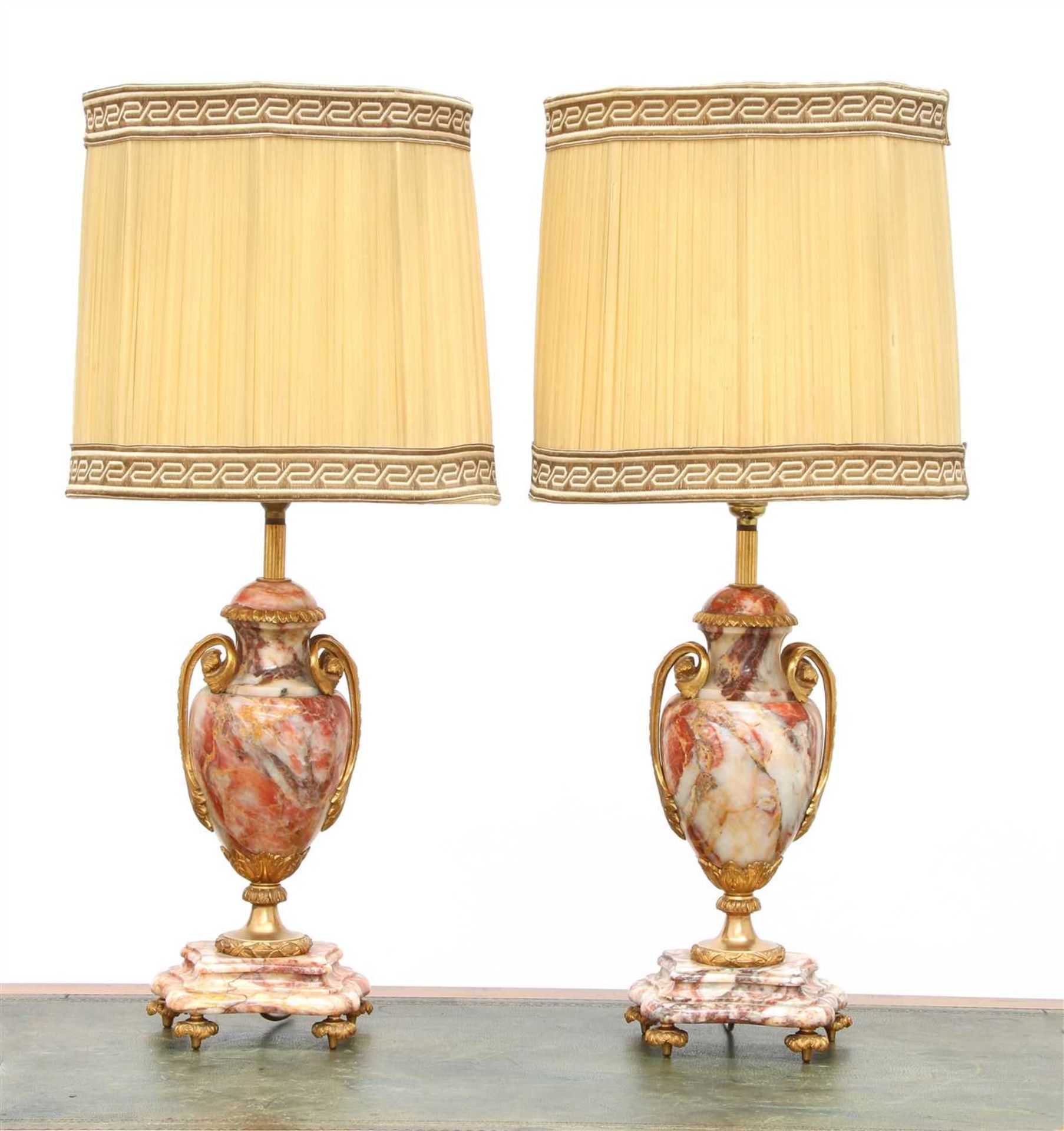 A pair of rouge veined marble table lamps,