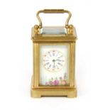 A miniature brass carriage clock,