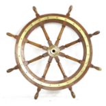 A teak and brass mounted eight spoke ship's wheel