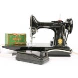 A Singer 221K portable sewing machine,
