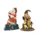 A near pair of Victorian polychrome painted cast iron Punch and Judy doorstops,