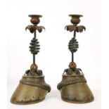 A pair of wrought iron and horse hoof candlesticks,