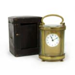 An oval French brass carriage clock,