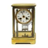 A late 19th century brass and four glass mantel clock