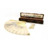 A late 19th century carved ivory and silk fan