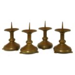 A set of four brass pricket candlesticks,