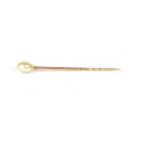 A cased pearl stick pin