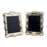 A pair of large silver photograph frames,