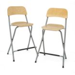 Eight modern folding tubular bar stools,