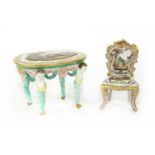 A French pottery miniature chair and table,