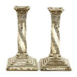 A pair of Edwardian corinthian column candlesticks,