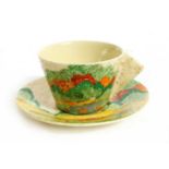 A Clarice Cliff `Patina' pattern tea cup and saucer
