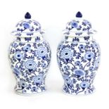 A pair of Chinese blue and white baluster vases and covers