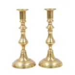 Four pairs of brass candlesticks,