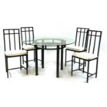 A Tom Faulkner wrought iron glass topped dining table and four chairs,