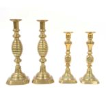 Two pairs of brass open twist candlesticks,