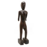 A carved wood female fertility figure