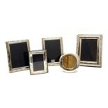 A collection of silver photograph frames,