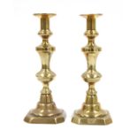 Four pairs of brass candlesticks,