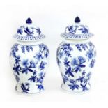 A pair of Chinese blue and white baluster vases and covers