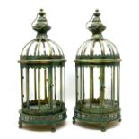 A pair of multi-faceted green patented metal hanging lanterns,