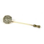 A Continental gold stick pin with an Art Nouveau medallion claw set in the top