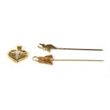 Two gold Springbok stick pins,