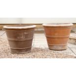A pair of large modern terracotta planters,