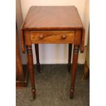 A Victorian mahogany drop flap work table, with a single drawer over turned tapering legs,