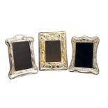 A collection of three silver photograph frames,