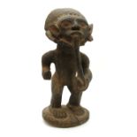 A large Cameroon (West Africa) carved wood figure of a man smoking a pipe,