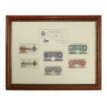 A framed display of British bank notes,