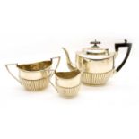 A Victorian silver three piece tea set by Walker and Hall,