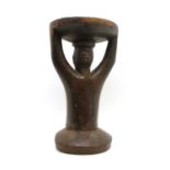 A Southern African carved hardwood figural stool,