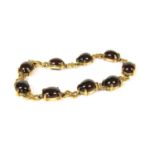 A 9ct gold cabochon garnet bracelet