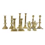 Four pairs of brass candlesticks,