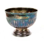 A silver fluted bowl raised on pedestal foot,