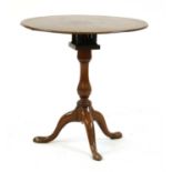 A mahogany tripod table,