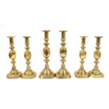 Three pairs of brass candlesticks,