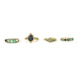 A gold five stone emerald cut emerald ring