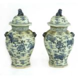 A pair of blue and white vases with covers,