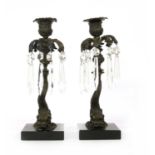 A pair of cast dolphin candlesticks,