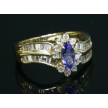 An American gold tanzanite and diamond crossover cluster ring