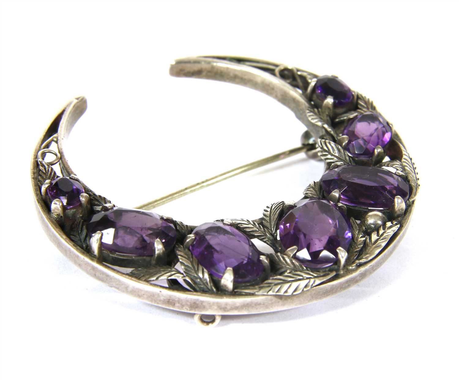 A silver Arts and Crafts amethyst crescent brooch