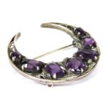 A silver Arts and Crafts amethyst crescent brooch