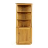 An Ercol elm corner cabinet,