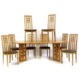 A modern oak extending dining table and eight chairs