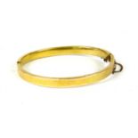 A hollow flat profile hinged bangle,