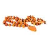 A single row graduated bouton shaped butterscotch amber bead necklace,